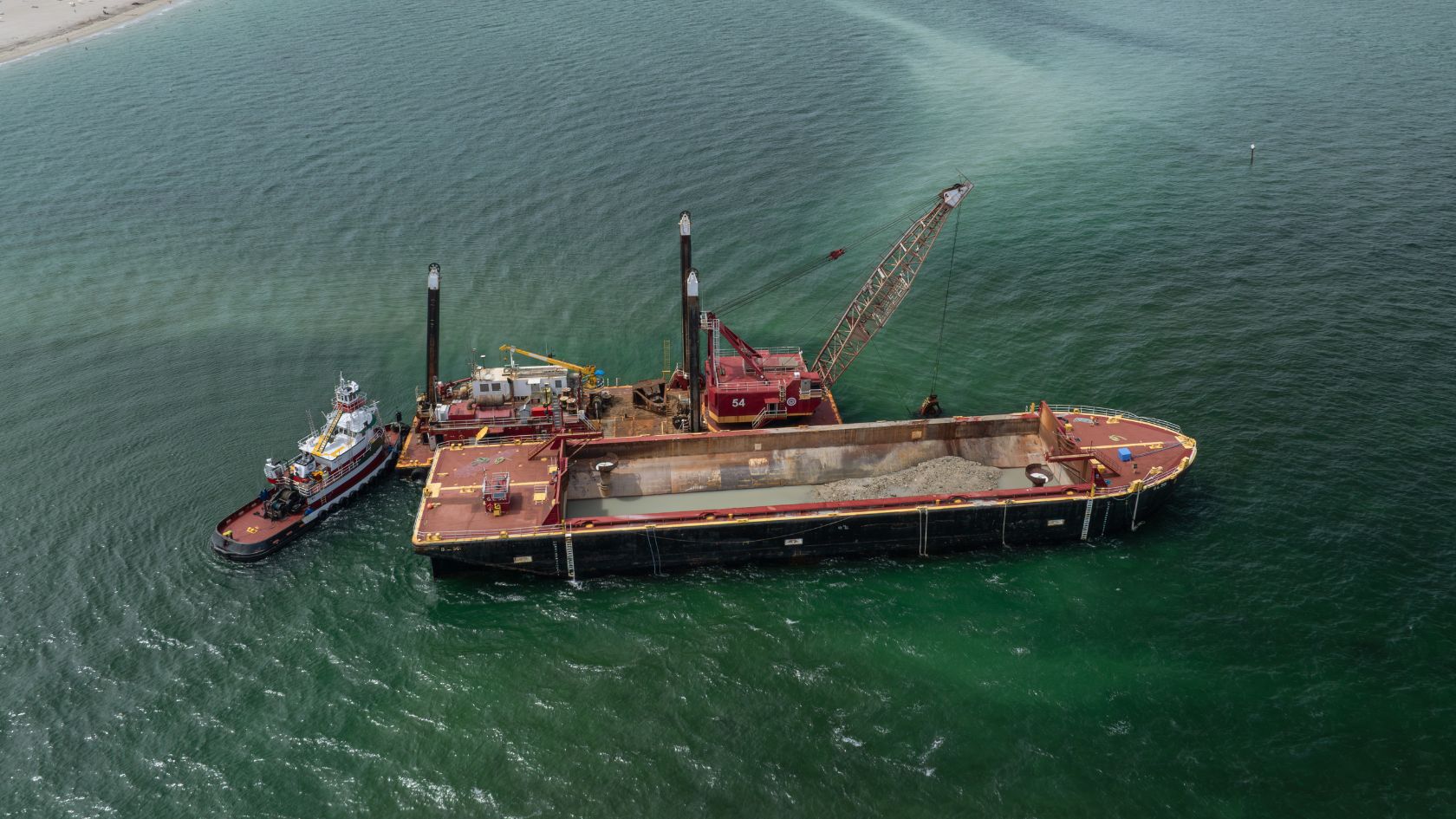 sand bypass dredge barge 54 sediment load aerial