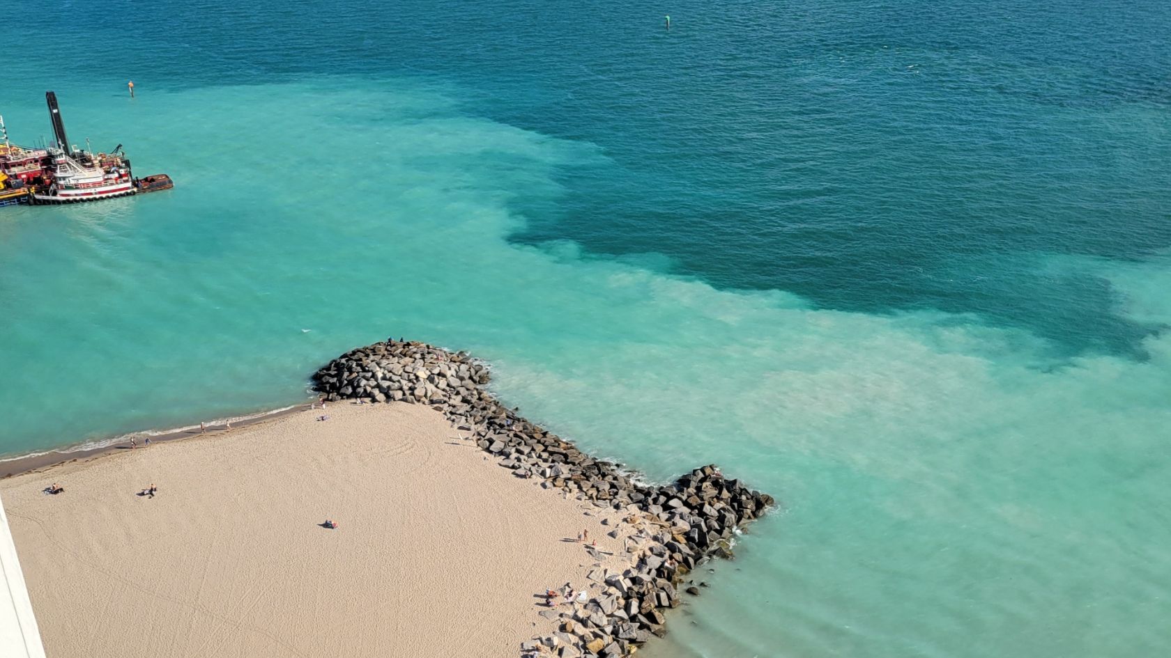 sand bypass turbidity plume jetty swimmers aerial